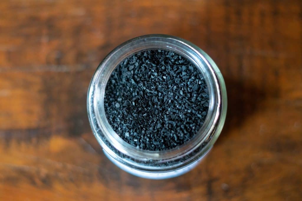 baking soda box next to activated charcoal bag on kitchen counter comparison