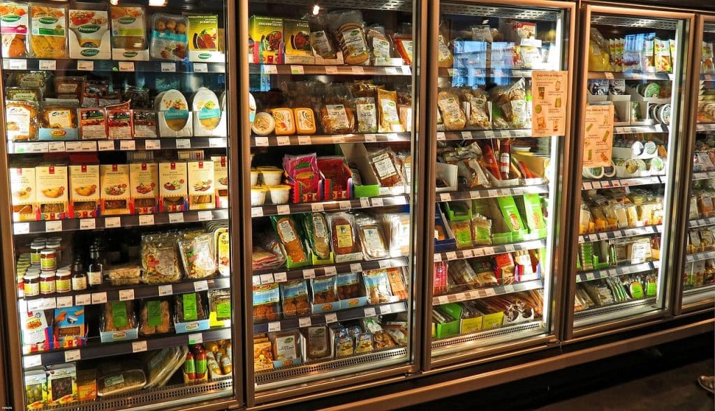 open refrigerator interior with various food items causing odor
