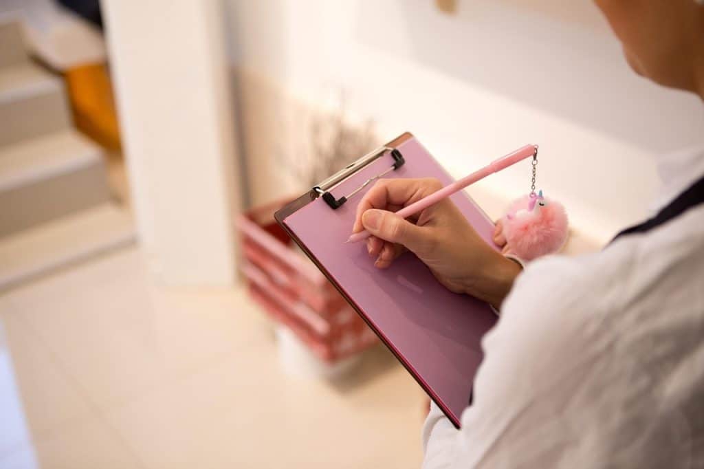 organized bathroom cleaning schedule checklist on clipboard