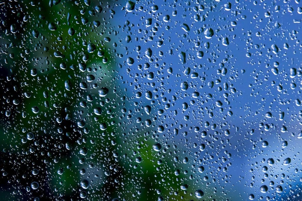 bubble wrap insulation film stuck on window glass with water spray bottle and squeegee tool