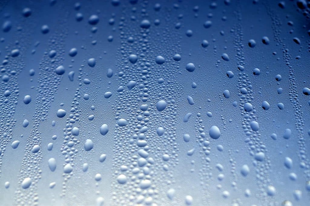 condensation water droplets on cold apartment window glass in winter morning