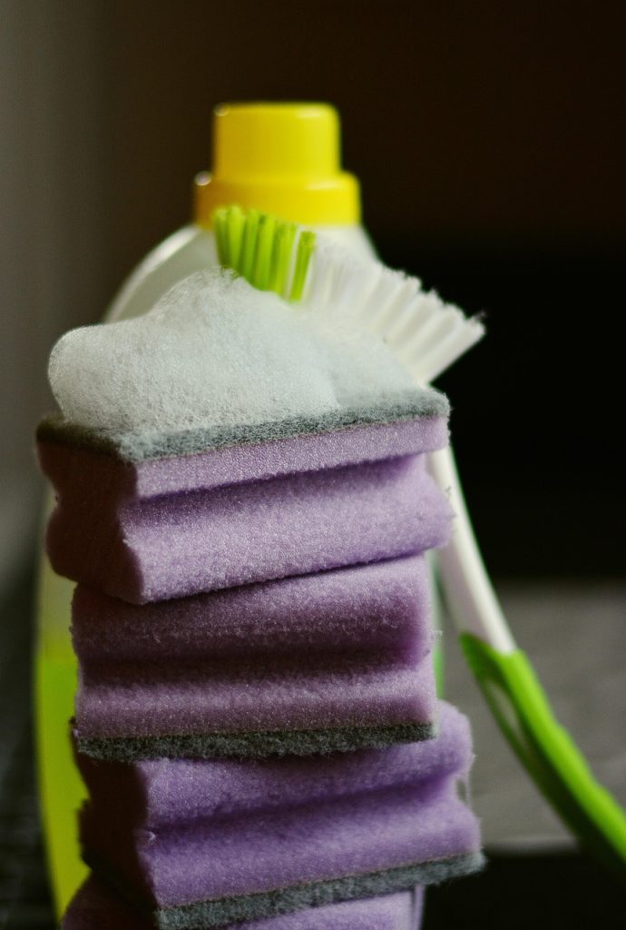 bleach cleaning toilet bowl with brush, foam visible