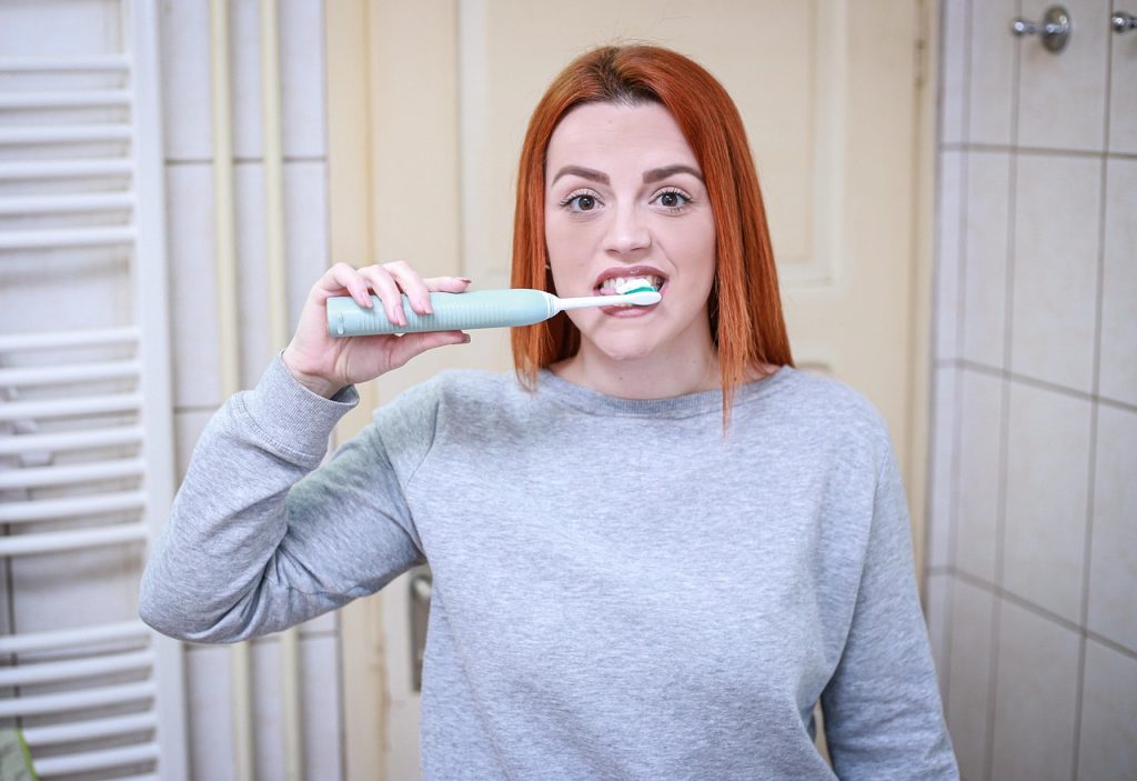disassembled U-trap pipe cleaning with toothbrush