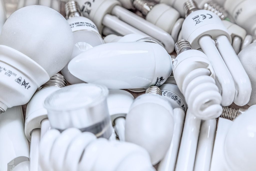 person removing old fluorescent tube by rotating it gently