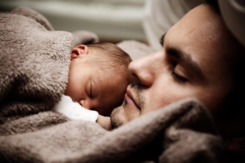father checking baby sleeping room at night with mosquito net