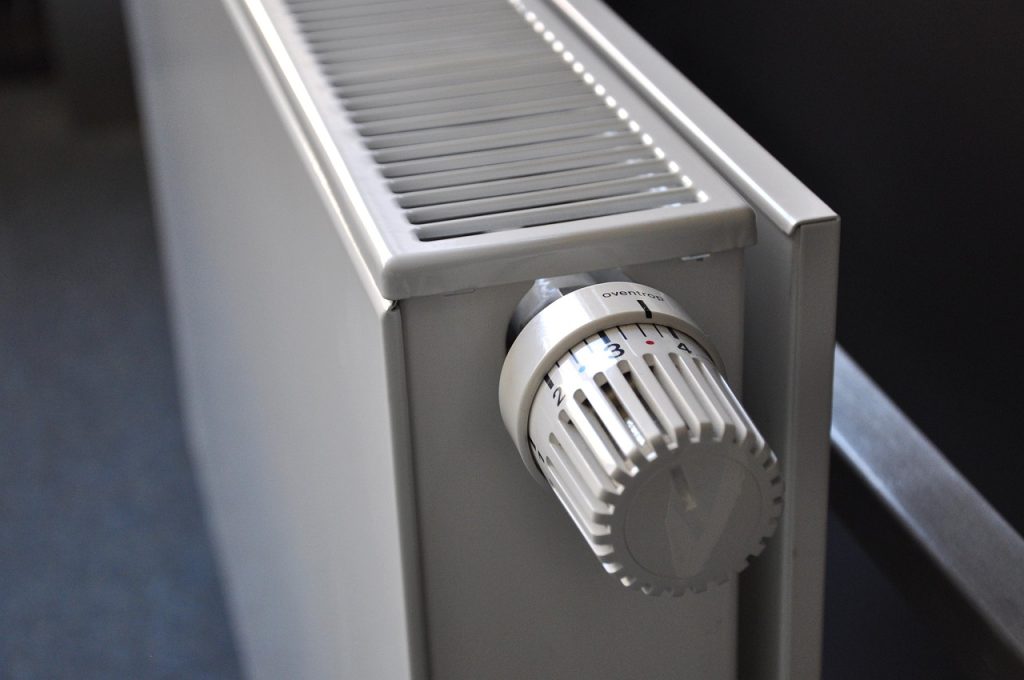 thermostat on wall showing temperature setting