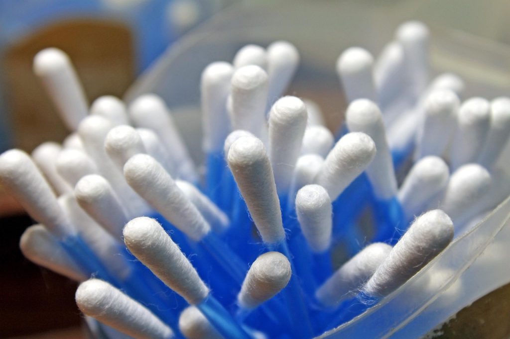 cleaning fluorescent light pin connectors with cotton swab