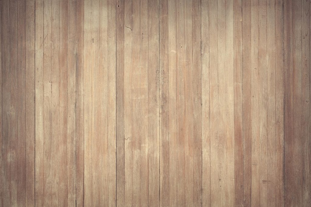 crushed heel counter of worn sneaker on wooden floor