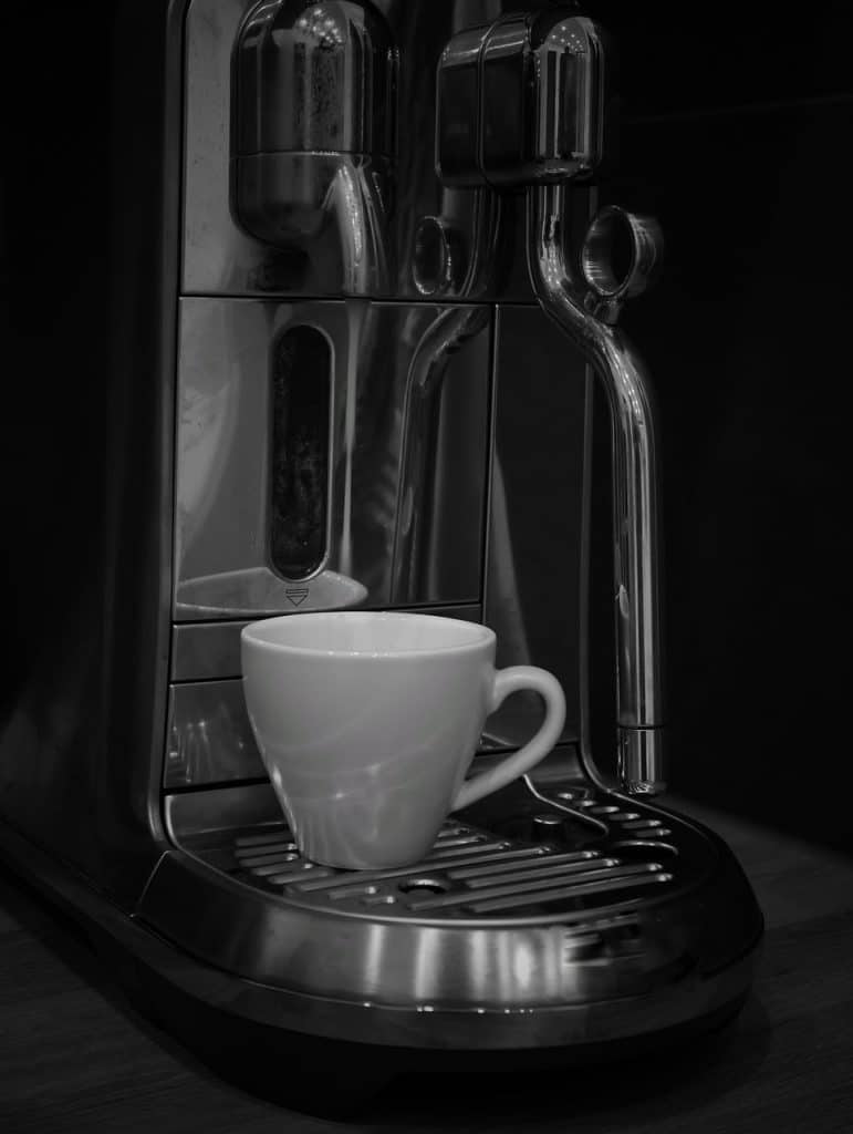 person dabbing coffee stain with white cloth correctly