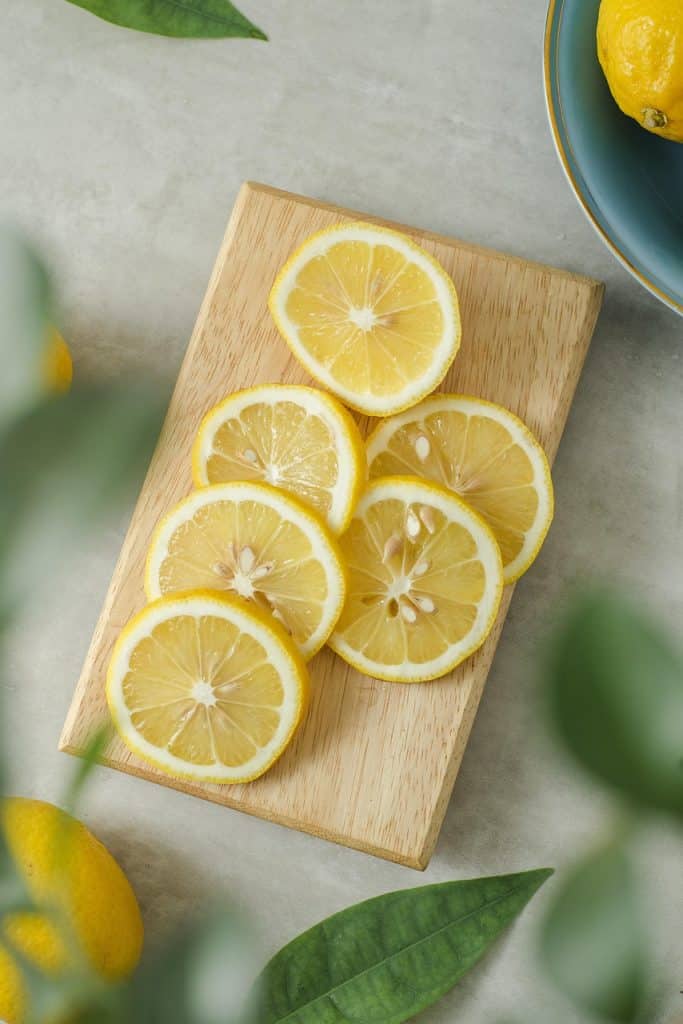 coarse salt and lemon half on wooden cutting board kitchen