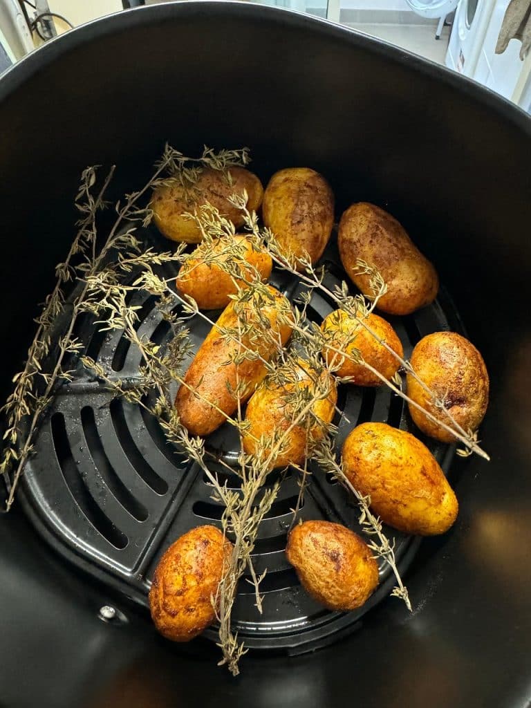 air fryer drip tray with accumulated grease being removed