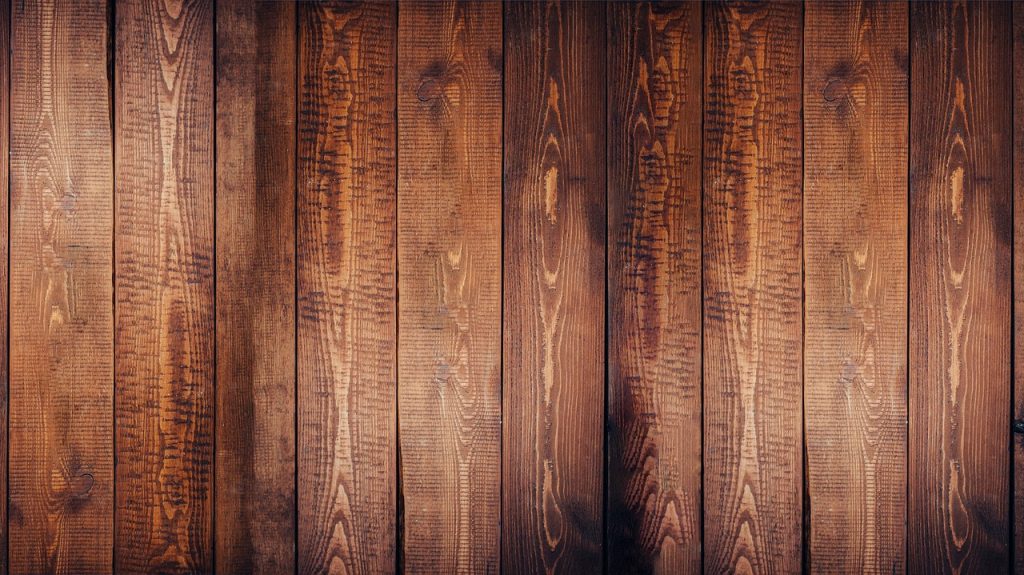 applying oil stick wax on natural oak hardwood floor in the direction of wood grain