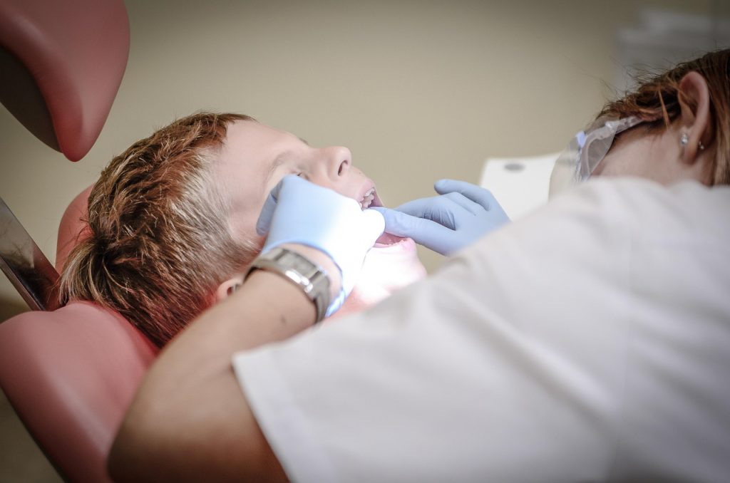 senior woman comparing dental prosthetics options with dentist