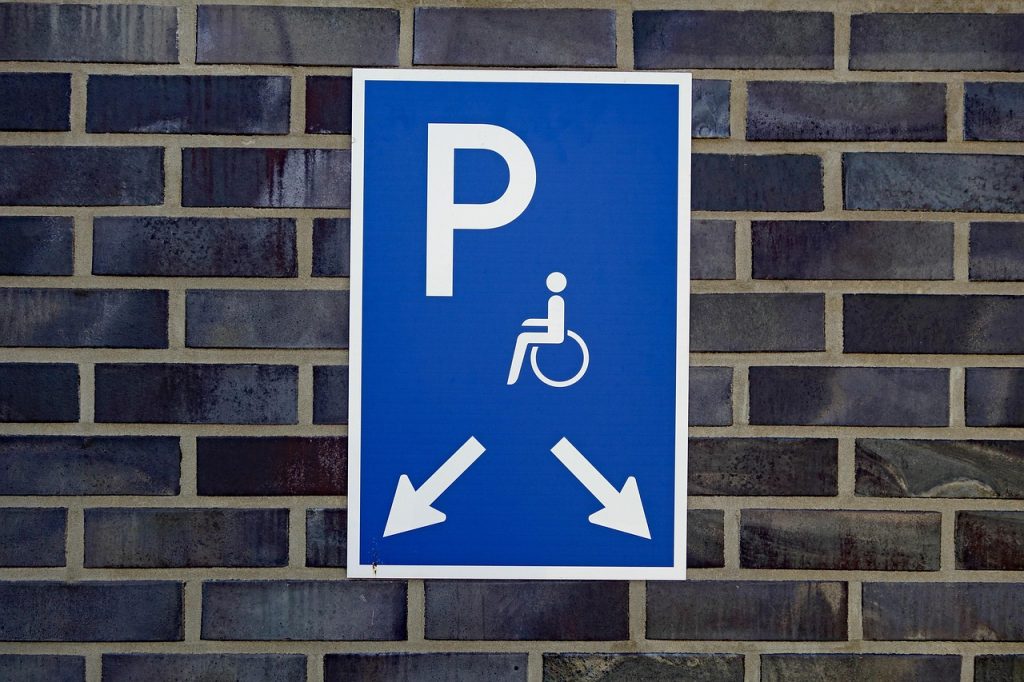 disabled parking permit and car keys on a desk