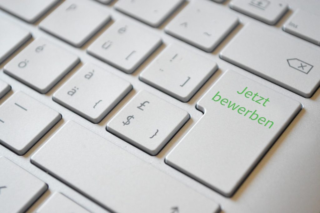 person filling out an online government job support application form on a laptop