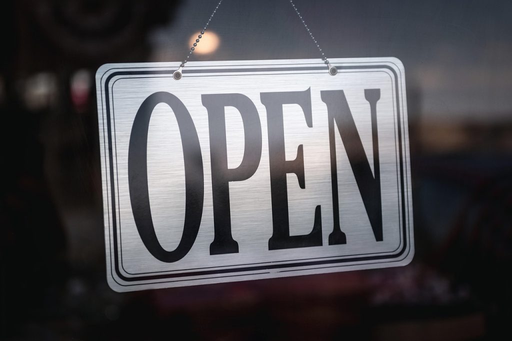 closed small business storefront with notice on door