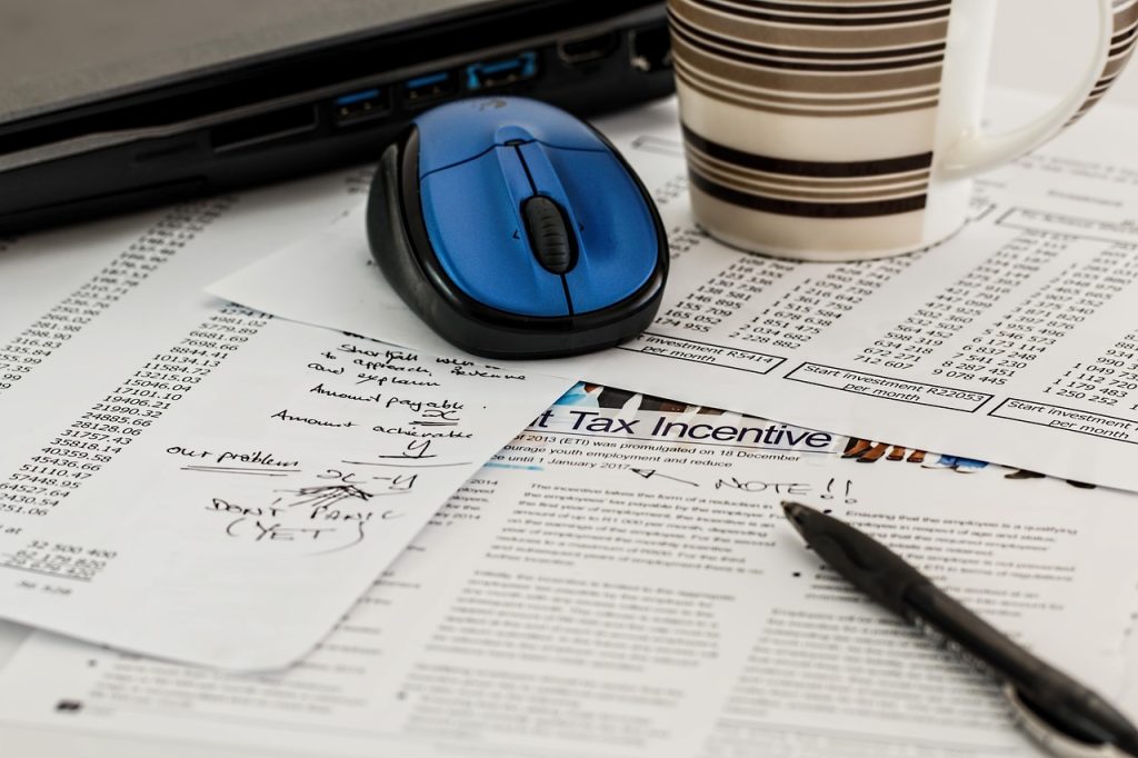 calculator and income documents on a desk