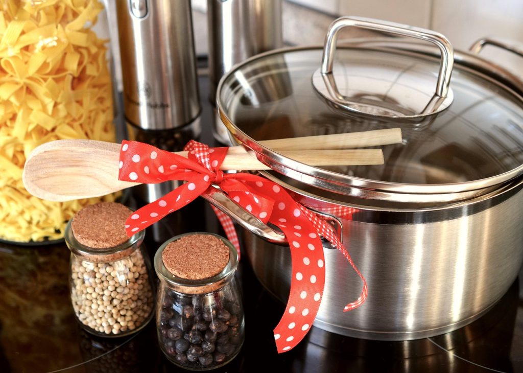 caregiver assisting elderly disabled woman with meal preparation in kitchen
