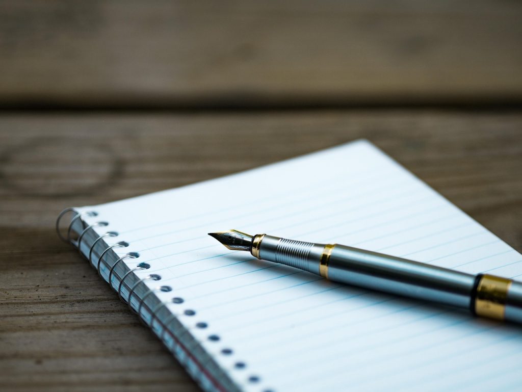 checklist on paper with pen on wooden table
