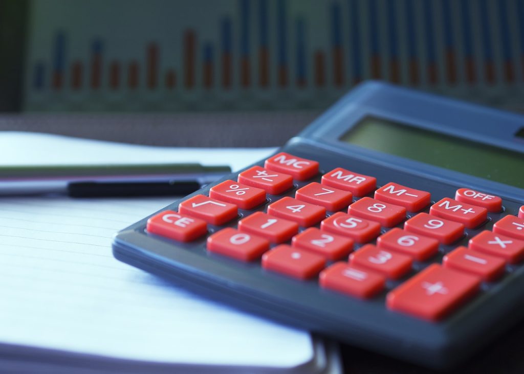 salary calculation notebook and calculator on desk