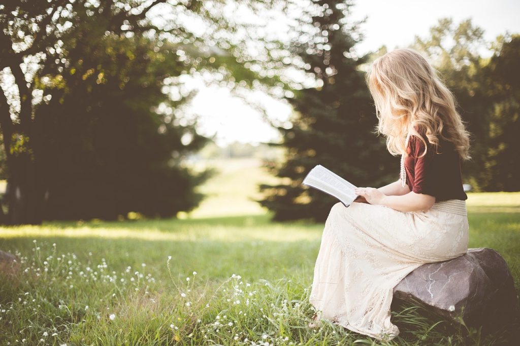 worried young Korean woman reading documents alone at night